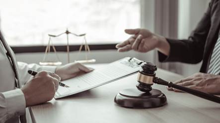 A judge and a gavel over a person's hand

AI-generated content may be incorrect.